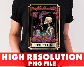 May include: Black t-shirt featuring a tarot card design with a skeleton enjoying tea. The card is framed with flowers and the text "THE TEA" is displayed. Below the design is the text "HIGH RESOLUTION PNG FILE".