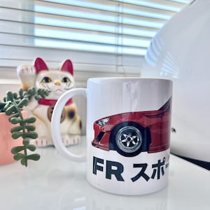 May include: White ceramic mug with a red sports car graphic and the text "FR スポーツ" on the front.
