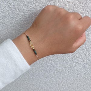 14 k gold filled bracelet to help you manifest Wealth. We are featuring malachite, citrine, tiger's eye, and pyrite.