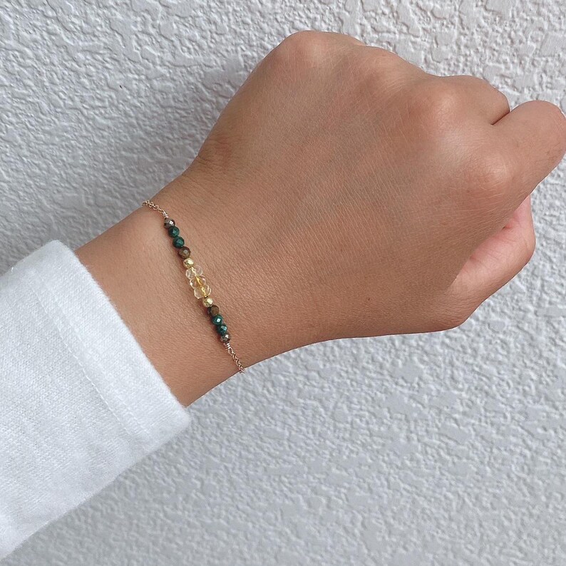 14 k gold filled bracelet to help you manifest Wealth. We are featuring malachite, citrine, tiger's eye, and pyrite.