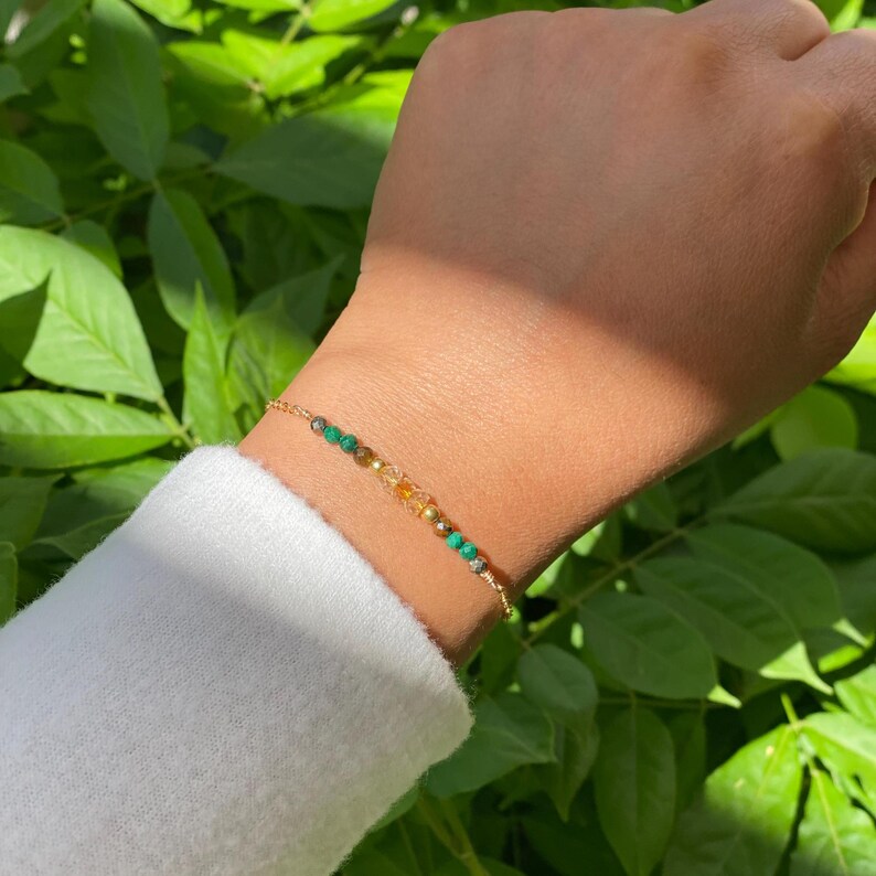 14 k gold filled bracelet to help you manifest Wealth. Featuring malachite, citrine, tiger's eye, and pyrite.