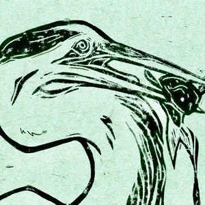 May include: A black and white linocut print of a bird with its beak open, possibly a gannet, with a fish in its beak. The print is on a light green background.