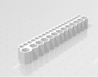 May include: A white plastic tool with a series of hexagonal holes, designed for holding and organizing various sizes of hex wrenches.