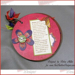 A handmade circle album showing off the vintage-style Well-Defined Backgrounds Unmounted Rubber Stamp set which has various dictionary definitions of words such as Birthday, Love, Art, Dream, Friend and more.
