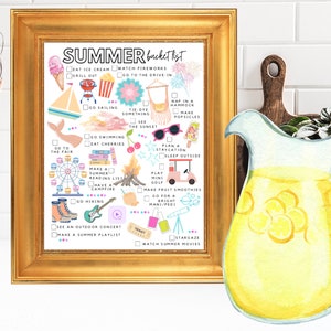 May include: A framed print with a gold border features a "Summer Bucket List" with colorful illustrations and checkboxes. The list includes activities like eating ice cream, watching fireworks, and stargazing. A watercolor pitcher of lemonade is on the right.