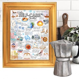 May include: A framed print with a gold frame featuring a watercolor "Winter Self-Care Checklist." The checklist includes self-care activities. A silver stovetop espresso maker sits in front of the frame. A wooden cutting board and a plant are in the background.