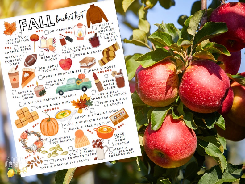 May include: A printed "Fall bucket list" featuring illustrations of autumn activities such as apple picking, making s'mores, and enjoying soup. The list includes various fall-themed items and activities, with a backdrop of red apples on a tree.