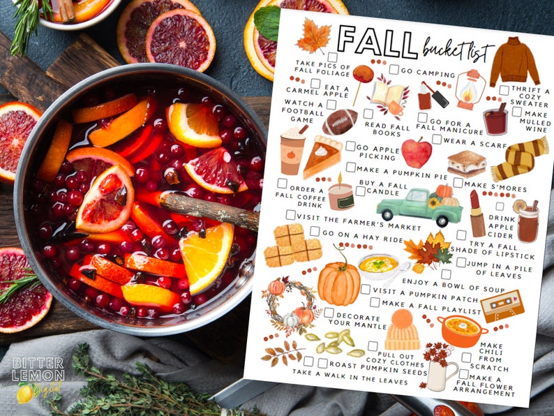 May include: An overhead shot shows a pot of mulled wine with orange slices and cranberries, next to a "Fall Bucket List" with autumn activities. The list includes apple picking, pumpkin pie baking, and enjoying fall foliage.
