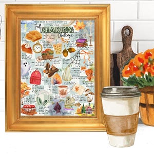 May include: A gold-framed print featuring a Fall Reading Challenge checklist. The artwork includes watercolor illustrations of autumn-themed items like pumpkins, leaves, books, a ghost, and a coffee cup, with text prompts for various reading tasks.