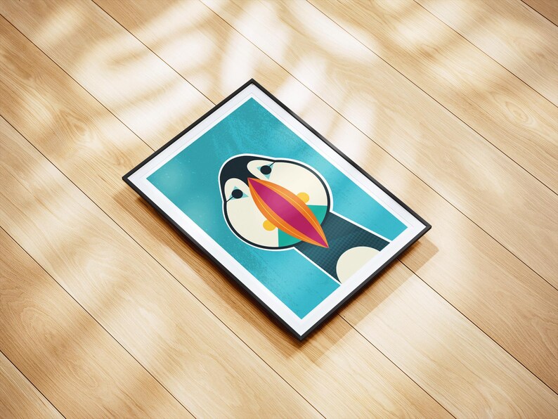 May include: A framed art print featuring a stylized illustration of a puffin bird. The artwork has a teal background with the puffin's face in the center, showcasing a large, colorful beak with orange, pink, and teal accents. The frame is black.