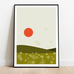 May include: A framed art print featuring a minimalist landscape. The artwork depicts a vibrant orange sun, rolling green hills, and a field of dotted circles. The sky is a pale beige, and the print is framed in black.