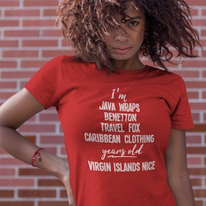 May include: Red t-shirt with white text that reads "I'm JAVA WRAPS BENETTON TRAVEL FOX CARIBBEAN CLOTHING years old VIRGIN ISLANDS NICE".