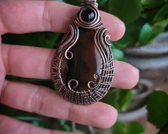 Montana agate with black onyx wirewrapped pendant.