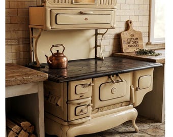 Antique wood-burning stove / classic 1920s glazed ceramic cooking stove / country house decor / cream and black cast iron.
