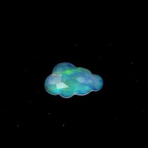 May include: A blue and green iridescent opal gemstone shaped like a cloud.