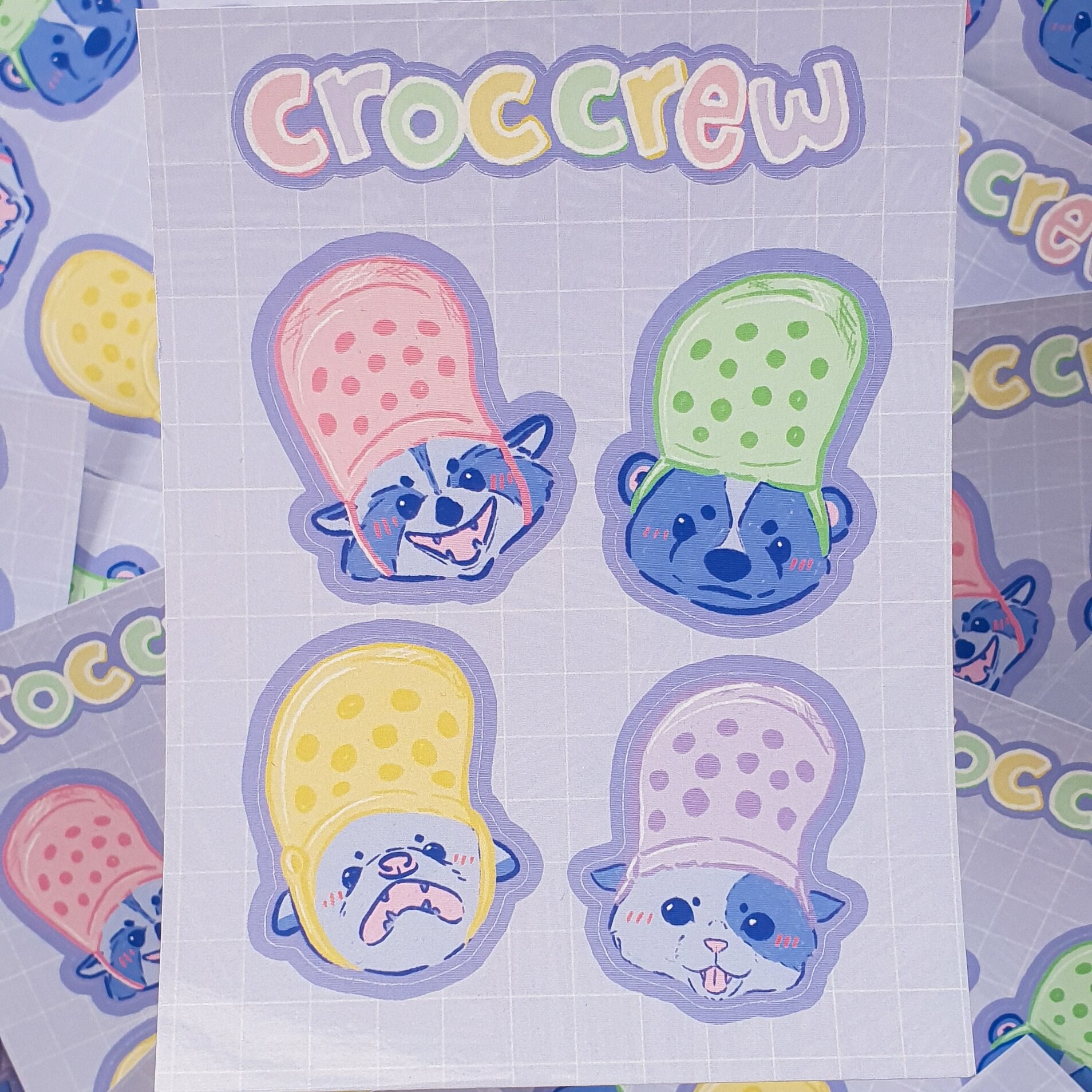 Croc Crew Sticker Sheet Featuring An Opossum, Skunk, Raccoon and Cat Wearing Crocs As Hats