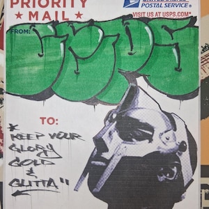May include: A white priority mail sticker with green graffiti art on top. The sticker has the text "PRIORITY *MAIL*" and "FROM:" at the top. The sticker also has the text "TO: * KEEP YOUR GLORY GOLD & GUTTA" at the bottom. The sticker has the text "UNITED STATES POSTAL SERVICE" and "VISIT US AT USPS.COM" at the top right corner. The sticker has the text "Label 228, March 2016" at the bottom left corner. The sticker has the text "FOR DOPE AND INTEN TIONAL USE" at the bottom right corner.