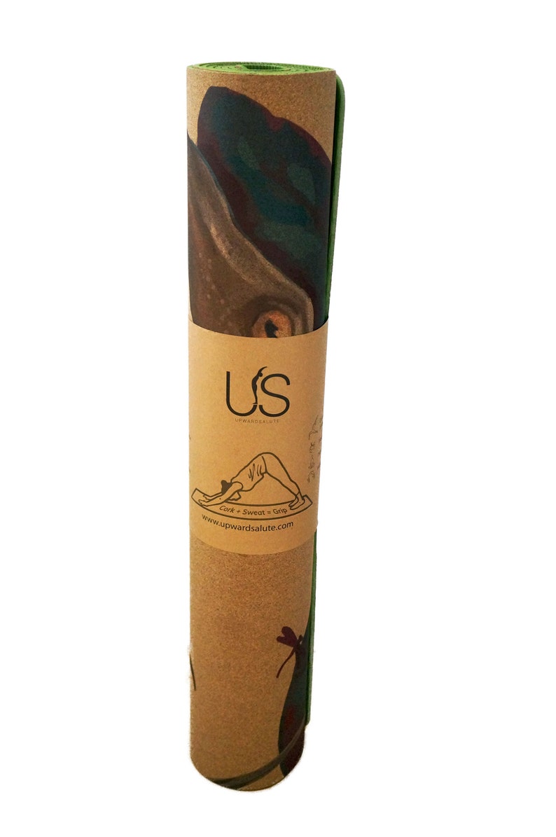 May include: Rolled up cork yoga mat with a green edge. The mat has a printed design of a dragonfly and the text "US Upwardsalute Cork + Sweat + Grip www.upwardsalute.com".