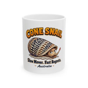 May include: A white ceramic mug featuring a graphic of a cone snail with a patterned brown shell. The text reads CONE SNAIL, Slow Mover. Fast Regrets. Australia. The snail has a tan body, a small red protrusion, and a focused facial expression.