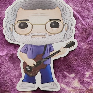May include: A sticker of a cartoon character playing a guitar. The character has a white beard, gray hair, and is wearing a purple shirt and blue jeans. The guitar is brown and has a white pickguard.