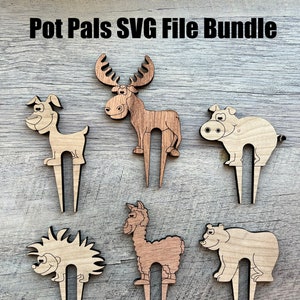May include: A collection of wooden plant pot stakes shaped like animals: a dog, moose, pig, hedgehog, llama, and bear. The stakes are light brown and have a two-pronged design. The text "Pot Pals SVG File Bundle" is displayed at the top of the image.