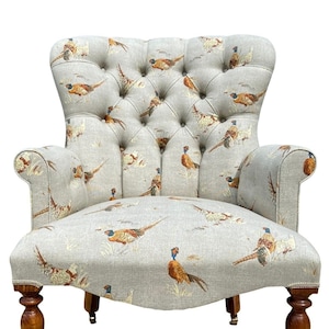 Armchair chair seat printed in a traditional pheasant/bird print on a beige background