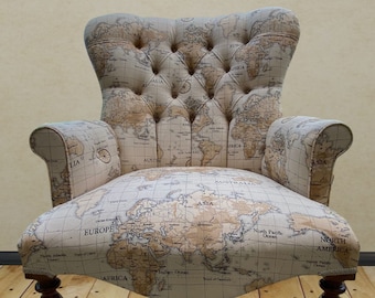 Armchair chair seat with a printed map of the world design on light biscuit background. Matching stool available.