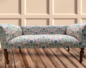 Occasional small sofa/bench/seat covered in printed red/blue/green floral/leaf design on linen natural.Matching Chair available.