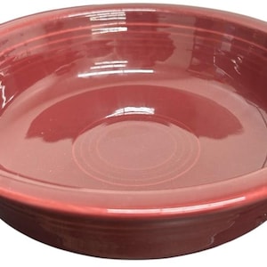 Może przedstawiać: Głęboka, czerwona ceramiczna miska z szerokim rantem i lekko pochylonym wnętrzem. Misa ma błyszczące wykończenie i prosty, klasyczny design. Ta miska nadaje się do serwowania sałatek, zup lub innych potraw.