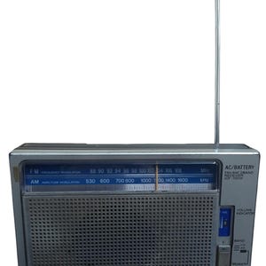 May include: A silver and grey Sony ICF-700W portable radio with an extendable antenna. The radio has FM/AM frequency bands, a volume indicator, and a power switch. The front has a speaker grill and the Sony logo.