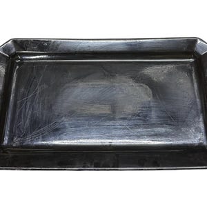 May include: A black rectangular serving tray with a slightly raised edge and a smooth, shiny surface.