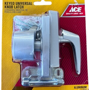 May include: A silver keyed universal knob latch with a handle and a strike plate. The packaging is yellow with the words "KEYED UNIVERSAL KNOB LATCH" and "ACE QUALITY SINCE 1924". The packaging also says "ALUMINUM ALUMINIO".