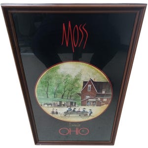 May include: A framed print featuring the word MOSS in red at the top and OHIO in red at the bottom. The central circular image depicts a rural scene with a red barn, trees, a horse-drawn carriage, and people in traditional clothing on a wagon.