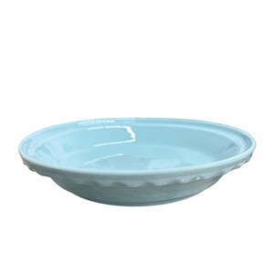 May include: A light blue ceramic pie dish with a scalloped edge. The dish is round and has a smooth, glossy finish. The pie dish is empty and ready for baking.