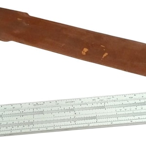 May include: A vintage slide rule with a white body and detailed markings, accompanied by a brown leather case. The slide rule is a tool for mathematical calculations, and the case shows signs of wear.