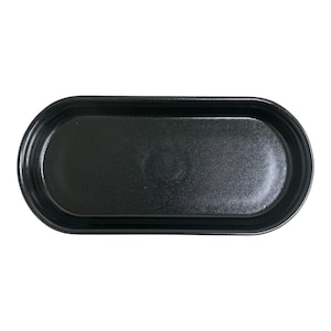 May include: A black, oval-shaped tray with a slightly textured surface. The tray has a raised rim and a subtle, circular design in the center. The overall shape is elongated, suitable for serving or display.