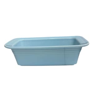 May include: A light blue rectangular ceramic baking dish. The dish has a slightly flared rim and three horizontal ridges on the sides. The interior is smooth and the exterior is a matte finish. This kitchenware is ideal for baking.