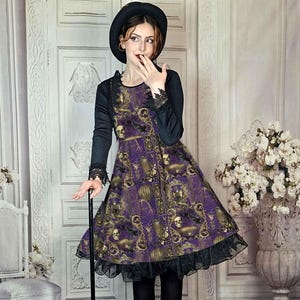 May include: A purple dress with a gothic print featuring skulls and ornate frames. The dress has long black sleeves with lace cuffs and a black ruffled hem. The person is wearing a black hat and boots, holding a black cane.