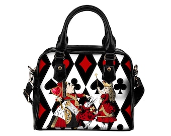 May include: A black handbag featuring a repeating red and black diamond pattern. The front displays a graphic illustration of a queen, a white rabbit, and a girl in a red dress. The bag has black handles, gold-tone hardware, and a detachable strap.