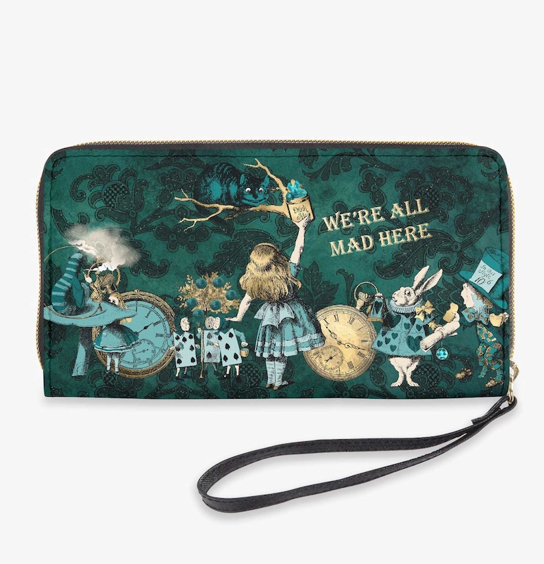 May include: A green zippered wallet with a whimsical Alice in Wonderland theme. The wallet features a green and gold patterned background with images of Alice, the Mad Hatter, the White Rabbit, and the Cheshire Cat. The text "We're All Mad Here" is printed in gold on the front of the wallet.