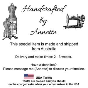 May include: A black and white graphic featuring the text Handcrafted by Annette, accompanied by illustrations of two dress forms on the left and a vintage sewing machine on the right. The design includes additional text regarding shipping and tariffs.