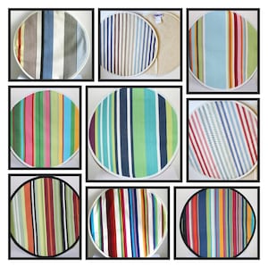 May include: Nine round striped fabric chair pads in various colour combinations. The pads feature a white border and are made of a woven fabric.