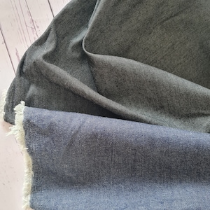 9 oz Stretch Denim: blue and black cotton 2% spandex. Dressmaking fabric for dungarees and jeans. Sold by the half metre