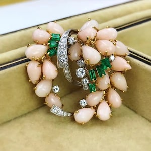 An 18k coral, diamond and emerald brooch