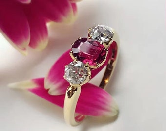 An early 20th century 18ct gold spinel and diamond three-stone ring