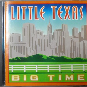 May include: CD case with the words "LITTLE TEXAS" in orange letters above a cityscape illustration. Below the cityscape is a green field with a white fence, and the words "BIG TIME" in white letters.