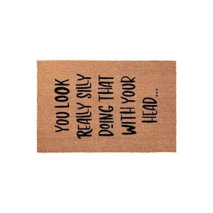 A textured area rug with a humorous message printed on it.