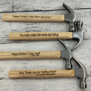 May include: Four miniature wooden hammers with engraved messages for Father's Day. The messages include "Happy Father's Day! Best dad ever!" "You really nailed this whole dad thing!" "Happy Father's Day Dad! Love, Alex" and "Dad, Thank you for Nailing Mom! Your favorite child, Kermet".