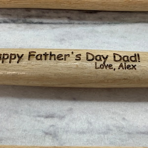 May include: A wooden rolling pin with the text "Happy Father's Day Dad! Love, Alex" engraved on it.