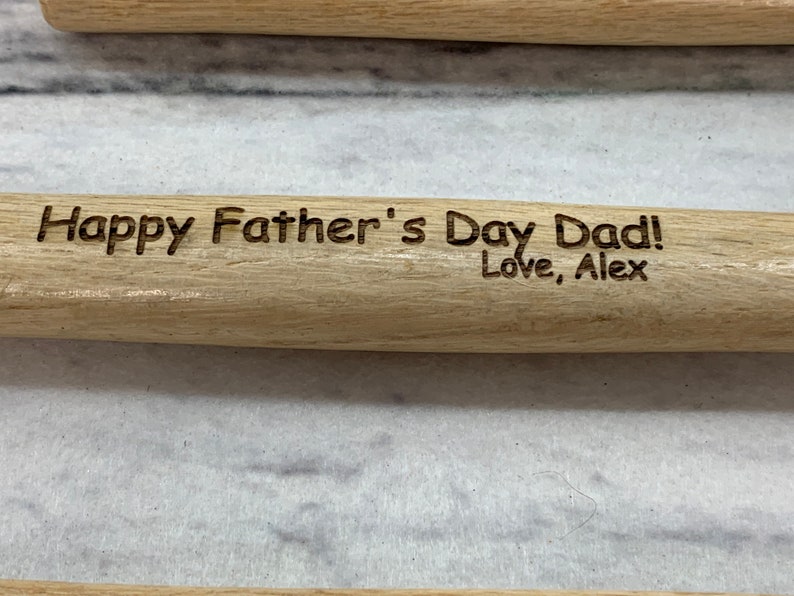 May include: A wooden rolling pin with the text "Happy Father's Day Dad! Love, Alex" engraved on it.